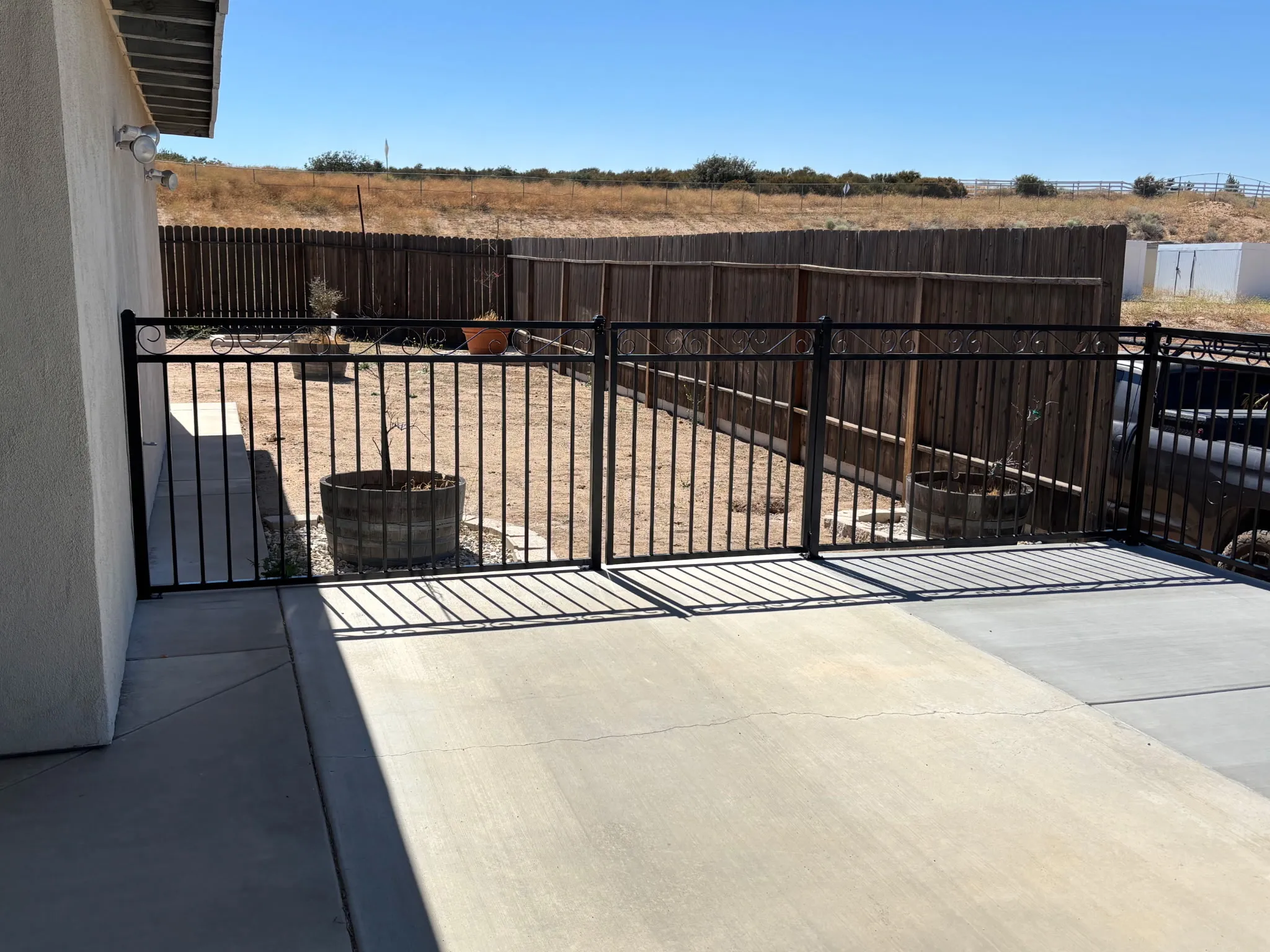 New wrought iron perimeter fencing installed along a high desert backyard